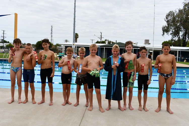 Primary boys and their ribbons at the swimming carnival.